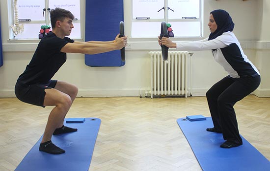 Instructor and client having a 1 to 1 pilates session