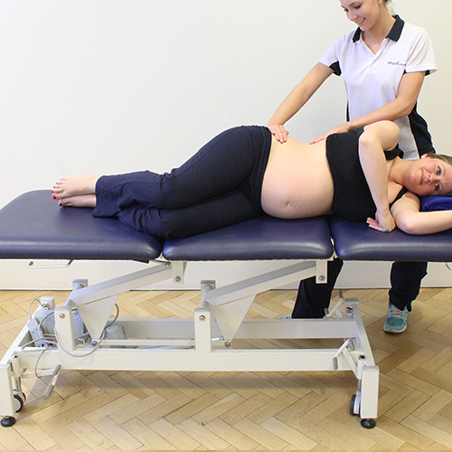 Physiotherapist assisting client with a press up