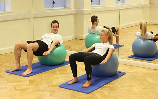 Instructors practicing new pilate techniques Instructors practicing new pilate techniques