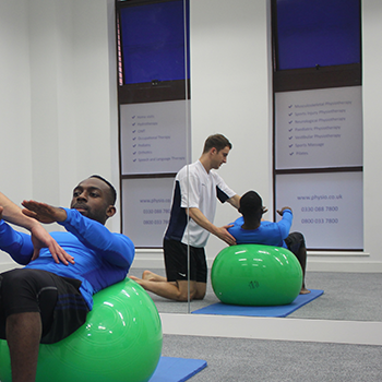 Pilates class completing simple stretch 